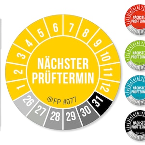 May include: A yellow and grey sticker with the text "NÄCHSTER PRÜFTERMIN" and numbers 1-12 around the edge. A black permanent marker is next to the sticker. Additional stickers in red, green, blue, and black are also shown.
