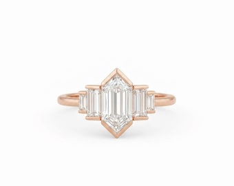 May include: Rose gold engagement ring featuring a central emerald-cut diamond flanked by four baguette-cut diamonds. The ring has a geometric design with a modern aesthetic. The diamonds are clear and sparkling, set against the warm hue of the rose gold band.