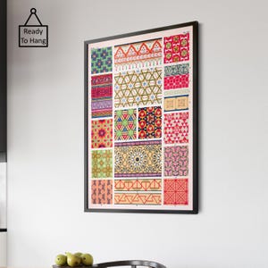 May include: A framed print displaying a variety of colourful geometric patterns. The patterns are arranged in a grid, showcasing designs in red, green, blue, and yellow. The black frame surrounds the print, which is labelled "Ready To Hang".
