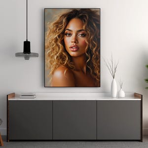 May include: A close-up portrait of a woman with long, curly brown hair. She is looking directly at the camera with a soft, warm expression. Her skin is smooth and her lips are slightly parted.