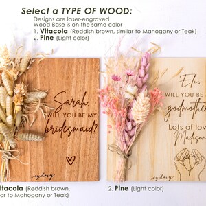 May include: Two wooden signs with dried flowers, one says "Sarah, will you be my bridesmaid?" and the other says "Eli, will you be my godmother? Lots of love Madison". The signs are available in two wood types: Vitacola (reddish brown) and Pine (light color).