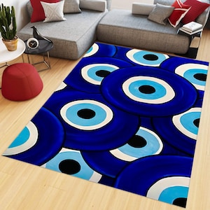 May include: A rectangular area rug featuring a repeating pattern of concentric circles in shades of dark blue, light blue, white, and black, resembling the design of a traditional nazar amulet, covering the floor in a living room setting.
