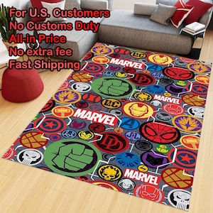 May include: A rectangular area rug featuring a repeating pattern of colorful circular Marvel superhero emblems, including the Hulk fist, Spider-Man mask, and Iron Man helmet, interspersed with the white Marvel logo on a gray grid background.