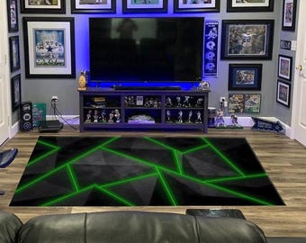 May include: A rectangular area rug featuring a dark gray and black geometric pattern composed of angular shapes. The design is accented by thin, vibrant neon green lines that intersect across the surface, creating a sharp, modern visual effect.