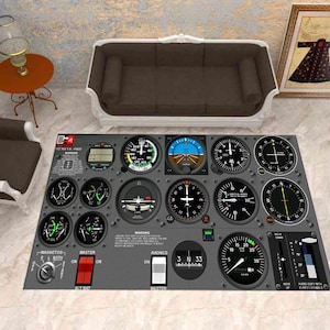 May include: A gray area rug featuring a detailed illustration of an aircraft instrument panel. The rug includes various gauges, dials, and warning labels, with text such as "WARNING" and "AVIONICS". The design incorporates a mix of black, white, blue, and green elements.