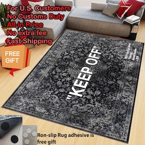 May include: A rectangular area rug featuring a black and white distressed floral pattern with the text KEEP OFF printed in large white capital letters. The rug includes a border design and small circular non-slip adhesive pads as accessories.