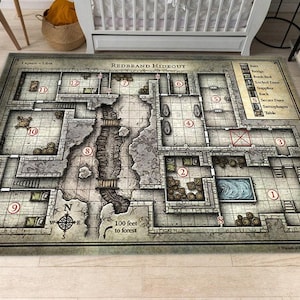 May include: A rectangular area rug featuring a detailed top-down dungeon map titled Redbrand Hideout. The design includes numbered rooms, a central chasm with bridges, a compass rose, and a legend. The color palette consists of muted grays, browns, and stone tones, with a grid overlay indicating that 1 square equals 5 feet.