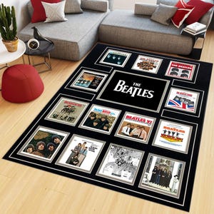 May include: A rectangular black area rug featuring a collage of various The Beatles album covers arranged in a grid pattern. The center of the rug displays the text The Beatles in white capital letters. The design includes multiple iconic images.