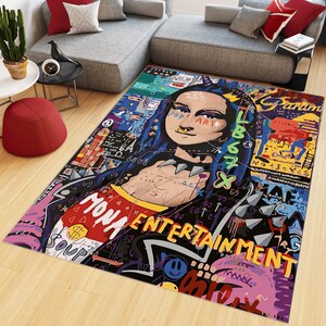May include: A colorful rug with a graphic design featuring a woman with blue hair and a black leather jacket. The design includes the words "Pop Art", "Mona Entertainment", and "Love".