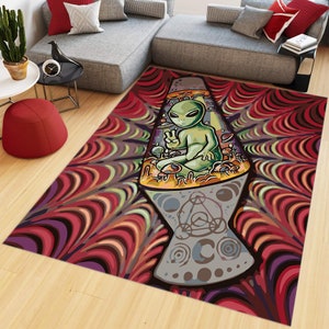 May include: A psychedelic rug with a lava lamp design featuring an alien sitting inside. The rug has a red, orange, yellow, green, blue, and purple color scheme with a swirling pattern.
