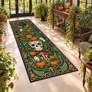 May include: A long rectangular runner rug featuring a black background with a detailed illustration of a human skull, orange pumpkins, mushrooms, green ferns, and small white ghosts, all framed by an ornate archway design.