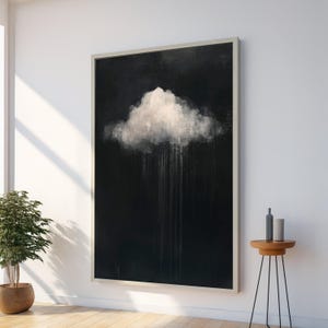 Peut inclure: Grande peinture abstraite encadrée représentant un nuage blanc sur fond noir. Le nuage présente des coups de pinceau texturés, avec des stries blanches verticales suggérant la pluie. L'œuvre est exposée sur un mur blanc.