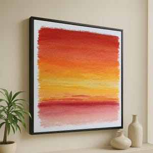 Puede incluir: Pintura abstracta de acuarela en un marco negro. La obra presenta un degradado de colores, que va del rojo intenso en la parte superior al amarillo y naranja en el medio, y un rojo más claro en la parte inferior. La pintura evoca una puesta o salida de sol.
