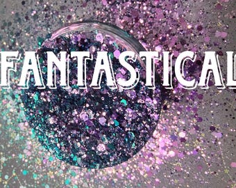 May include: A close-up of a clear container filled with iridescent glitter in shades of purple, blue, and green. The word "FANTASTICAL" is written in white letters across the top of the container.