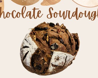 May include: A close-up of a chocolate sourdough bread loaf with pecans and raisins. The bread has a dark brown crust and a soft, fluffy interior.