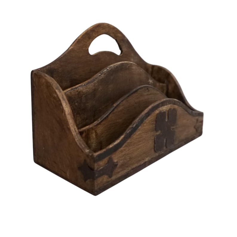 May include: A wooden desk organizer with a handle and three compartments. The organizer is stained a dark brown color and features decorative metal accents. The design is rustic and suitable for home or office use.