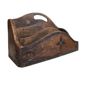May include: A rustic wooden desk organizer with three compartments and a handle. The organizer is stained a dark brown color and features decorative metal accents and a floral design. The wood grain is visible, giving it a vintage look.