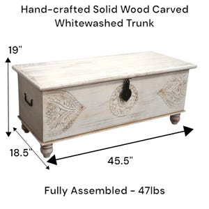 May include: Whitewashed wooden trunk with carved details and a hinged lid. The trunk measures 115.6 cm long, 47 cm wide, and 48.3 cm high. It weighs 21.3 kg.