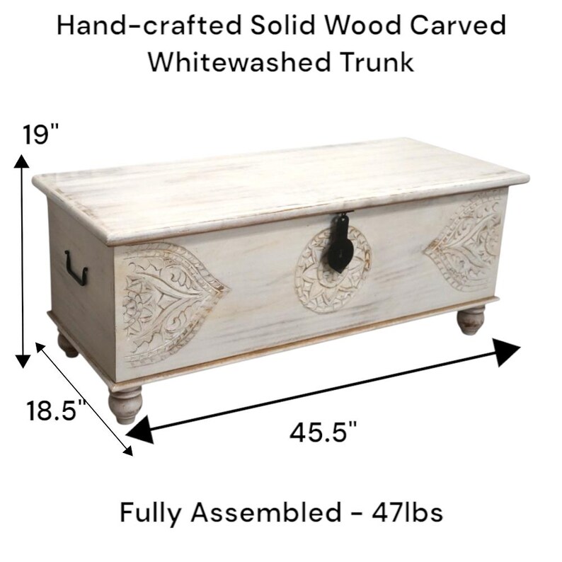 May include: Whitewashed wooden trunk with carved details and a hinged lid. The trunk measures 115.6 cm long, 47 cm wide, and 48.3 cm high. It weighs 21.3 kg.