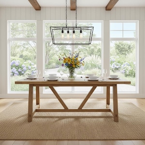 May include: A dining room scene featuring a large wooden table set for a meal. A black geometric chandelier hangs above. A vase of colorful flowers sits in the center. The room has large windows overlooking a garden.