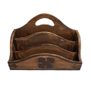 May include: A wooden desk organizer with a handle, featuring three compartments. The organizer has a dark brown finish with decorative details, including a four-leaf clover design and star-shaped accents.