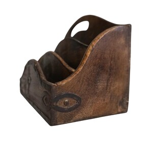 May include: A rustic, brown wooden desk organizer with three compartments and a handle. The organizer features decorative metal accents and is designed to hold mail, documents, or office supplies. The wood has a distressed finish.