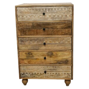 May include: A six-drawer wooden chest. The chest is made of light brown wood with a natural finish. The top and bottom drawers have a carved design. The drawers have black knobs and are supported by small, rounded feet.