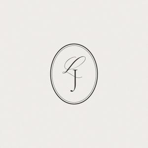 May include: An elegant, minimalist design featuring the intertwined letters "L" and "J" in a delicate, cursive script. The initials are enclosed within a black oval frame, set against a soft, off-white background. This design is suitable for stationery or branding.