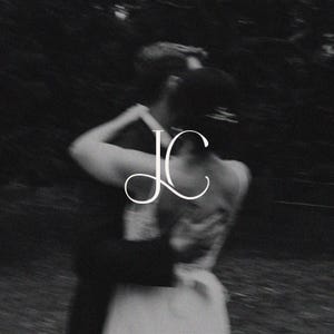 May include: Black and white image of a couple embracing. The woman is wearing a white dress. The initials "JC" are in white script in the upper left corner. The background is blurred, suggesting an outdoor setting.