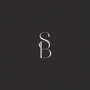 May include: Elegant white monogram logo featuring the letters "SB" in a stylized, flowing script. The design is set against a solid, dark gray background, creating a contrast that highlights the delicate typography. Ideal for branding or personal use.