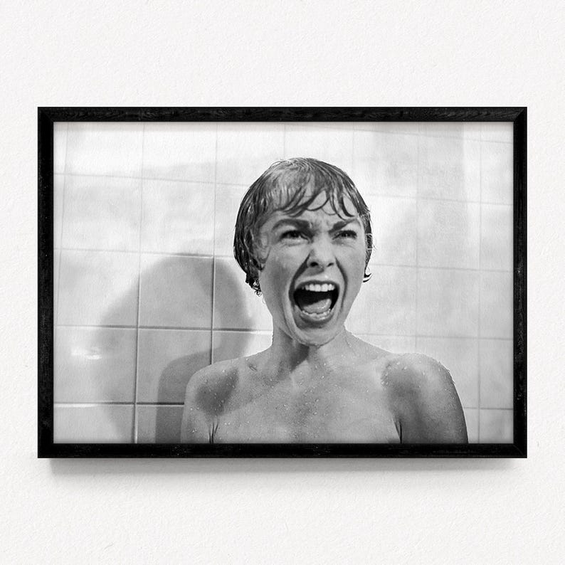 May include: Black and white framed print of a woman screaming in a shower. The image is a close-up, capturing the woman's face and open mouth. The background features white tiles.