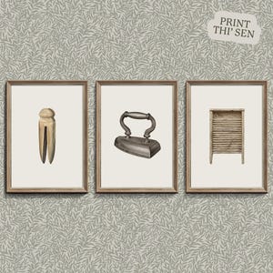 May include: Three vintage laundry items in framed illustrations: a wooden clothespin, a cast iron flat iron, and a wooden washboard.