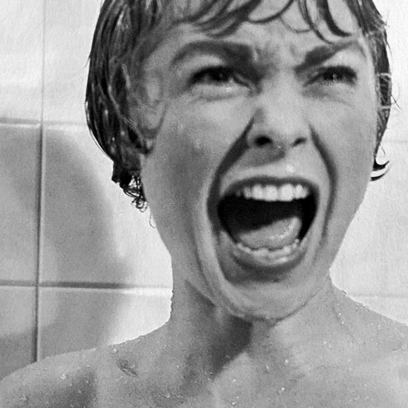 May include: Black and white image of a person screaming with mouth wide open. The person's face is contorted in a look of terror. Water droplets are visible on the skin and hair. The background is a tiled wall.
