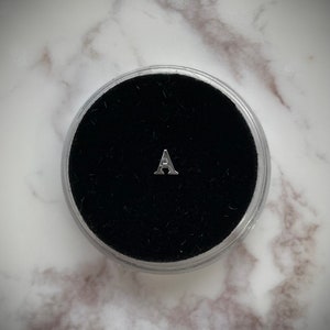 Gema de dente de prata “A”