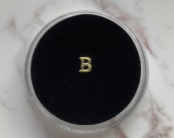 金の「B」歯の宝石