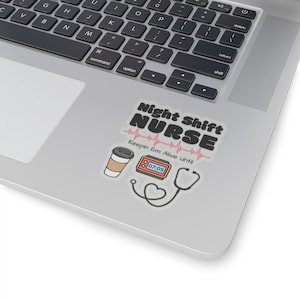 May include: A sticker with the text "Night Shift Nurse" in black text with a pink heartbeat graphic. The sticker also includes a coffee cup, a clock with the time 07:05, and a stethoscope with a heart.