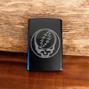May include: Black lighter with a silver engraved Grateful Dead Steal Your Face logo.