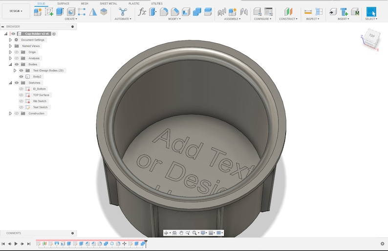 May include: A 3D model of a cup with a gray, textured surface. The inside of the cup has the text "Add Text or Design" engraved on the bottom.