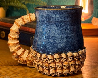 Catacombs Skull & Spine mug decorated with layers of hand-sculpted skulls and bones