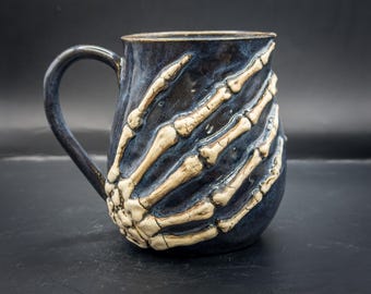 Handmade Halloween Skeleton Mug: Gripping Bone Hands, Dark Blue Ceramic