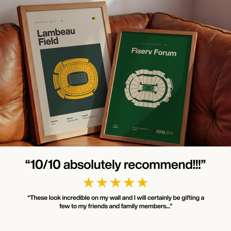 May include: Two framed prints with wooden frames. One features a green and yellow stadium design with "Lambeau Field" text. The other print has a green background with a white stadium design and "Fiserv Forum" text. The prints are leaning against a brown leather couch.