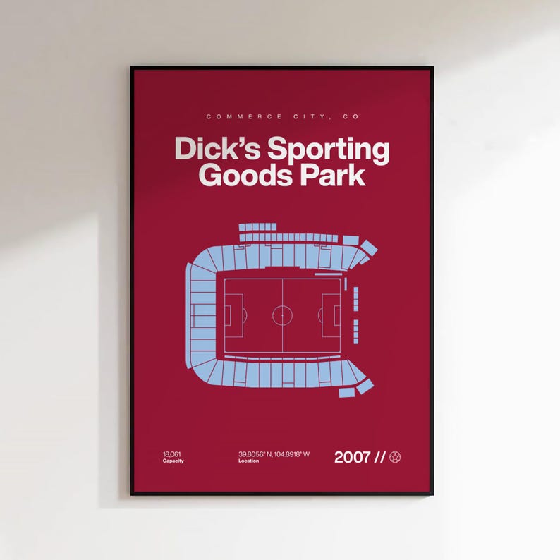 May include: A framed poster with a burgundy background features a light blue stadium schematic. The text reads "Dick's Sporting Goods Park" and "Commerce City, CO." Additional text includes the stadium's capacity, location coordinates, and the year 2007.