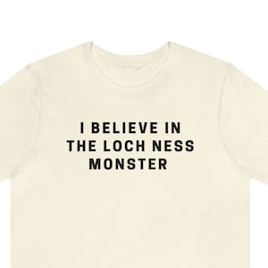 I Believe In The Loch Ness Monster | Scotland Sea Monster Funny Cute Graphic T Shirt | Cryptid Unisex Short Sleeve Tee