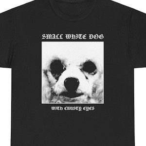 May include: Black t-shirt featuring a white graphic of a small white dog with the text "small white dog with crusty eyes" printed on it.