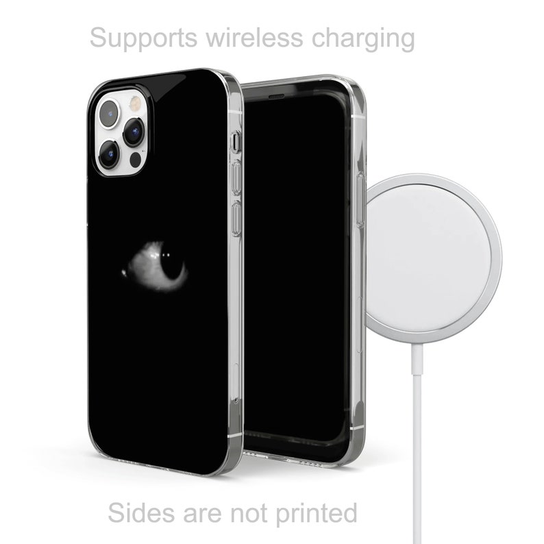 May include: A black phone case with a white eye graphic. The case is compatible with wireless charging. The phone case is shown next to a wireless charging pad.