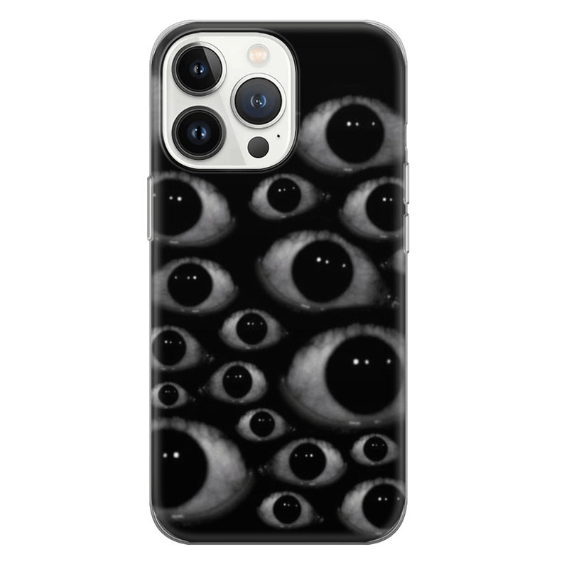 May include: A clear phone case with a black background and a pattern of many white eyes. The phone case has a cutout for the camera lens.