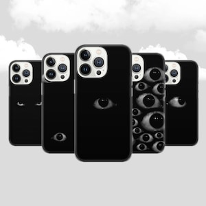 May include: Five black iPhone cases with different designs. One case features a single eye, another has two eyes, and the remaining three cases have multiple eyes.