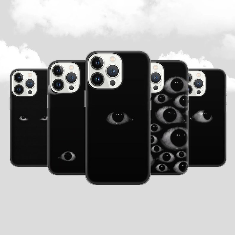 May include: Five black iPhone cases with different designs. One case features a single eye, another has two eyes, and the remaining three cases have multiple eyes.
