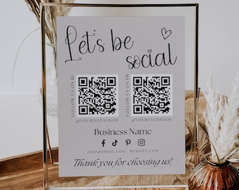 May include: A framed sign with the text "Let's be social" and two QR codes. The QR codes are labelled "Follow us on IG" and "Follow us on FB". The sign also includes the text "Business Name" and social media icons for Facebook, TikTok, Pinterest, and Instagram. The text "Thank you for choosing us!" is at the bottom of the sign.