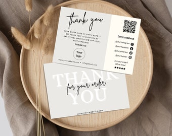 May include: A thank you card with a gray background and black text. The card says "Thank you" in large white letters and "for your order" in smaller black letters. The card also includes a QR code and social media handles.